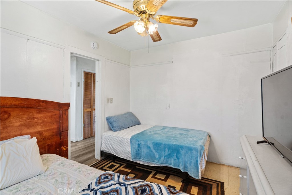 2113 Princeton Street Delano, CA 93215 - Photo 20 of 32 a bedroom with a bed and a chandelier