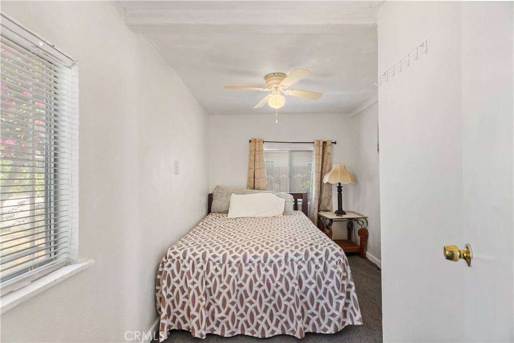 2113 Princeton Street Delano, CA 93215 - Photo 21 of 32 a bedroom with a large bed and a chandelier