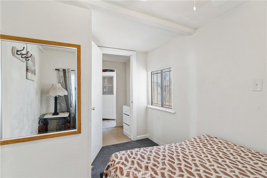 2113 Princeton Street Delano, CA 93215 - Photo 22 of 32 a bedroom with a bed and a lamp on dresser