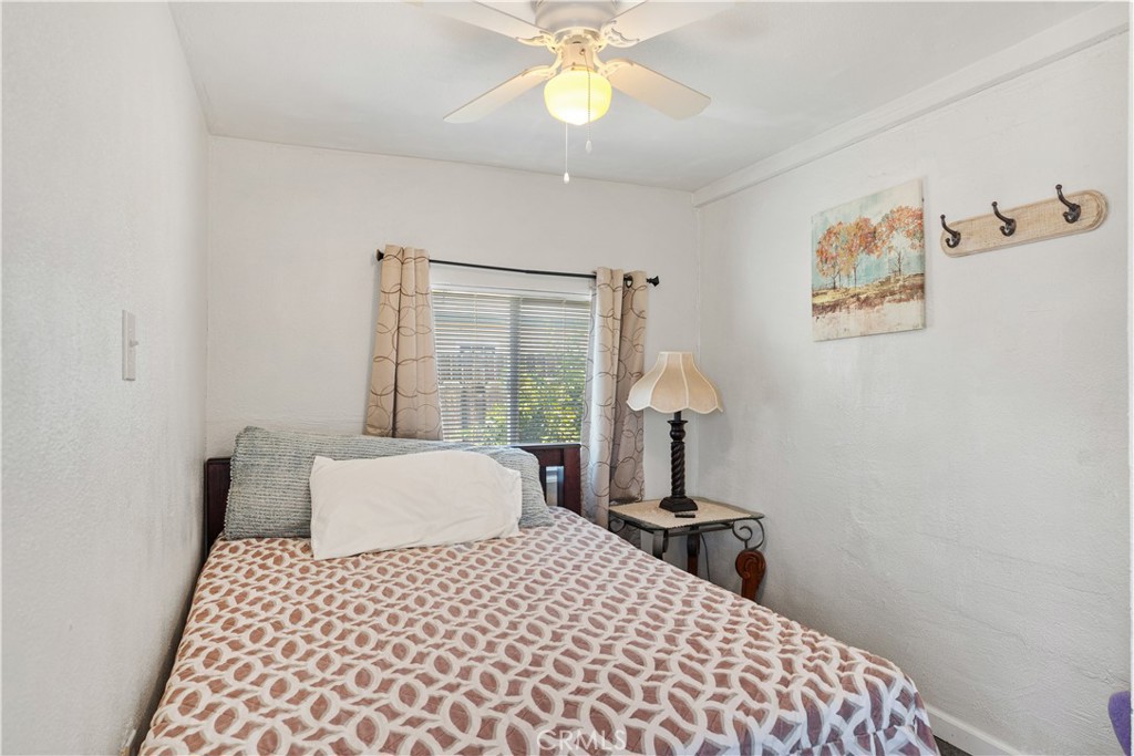 2113 Princeton Street Delano, CA 93215 - Photo 23 of 32 a bedroom with a bed and a chandelier