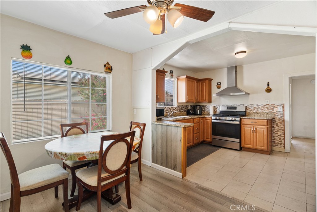 2113 Princeton Street Delano, CA 93215 - Photo 6 of 32 a kitchen with granite countertop a sink dining table and chairs