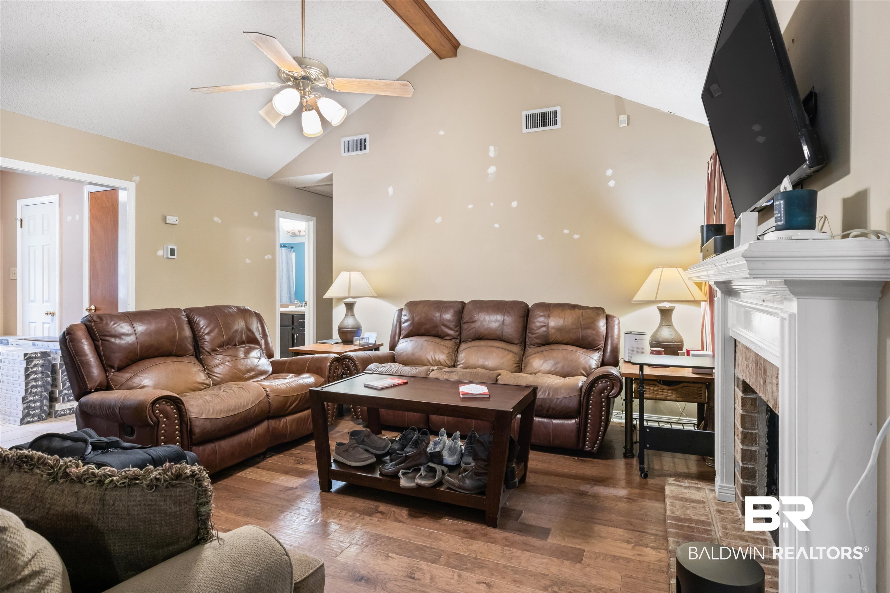 1345 Baker Court Mobile, AL 36695 - Photo 8 of 28 Living room featuring dark wood-type flooring, beamed ceiling, a fireplace, and ceiling fan