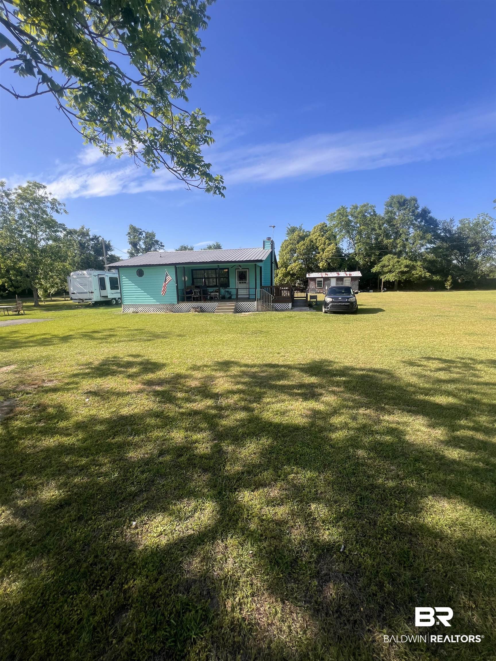 20925 Brinks Willis Road Foley, AL 36535 - Photo 2 of 9 Rear view of property with a yard and a deck