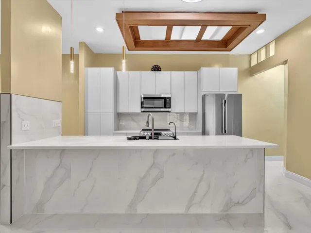 a view of a hallway with wooden shelves