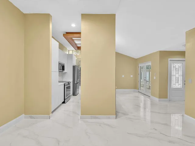 a kitchen with stainless steel appliances a sink and a refrigerator