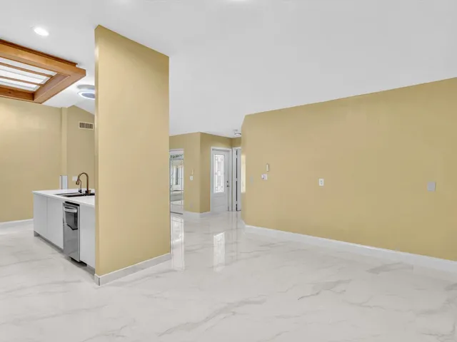 a kitchen with stainless steel appliances granite countertop a sink and a refrigerator