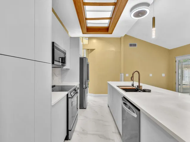 a view of a kitchen with a sink and a kitchen view