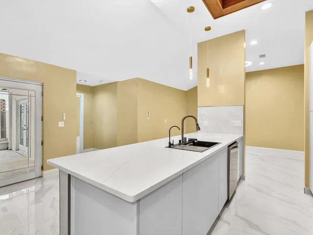 a kitchen with a sink stainless steel appliances and cabinets