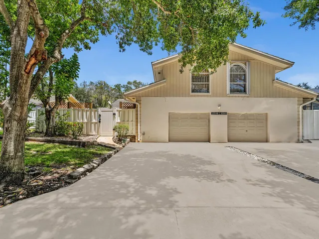front view of a house with a yard and a trees