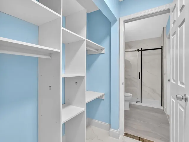 a bathroom with a granite countertop shower a mirror and a sink