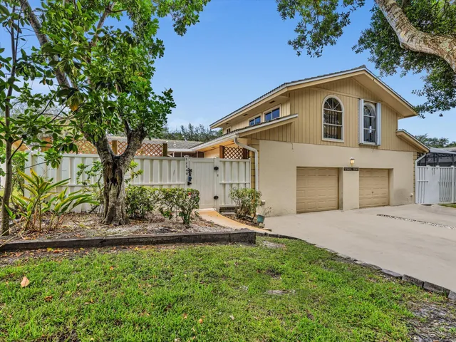 a front view of a house with a garden and plants