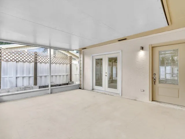 an empty room with sliding glass door and outdoor space