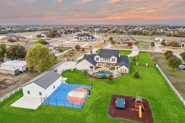 an aerial view of a house with garden space and ocean view