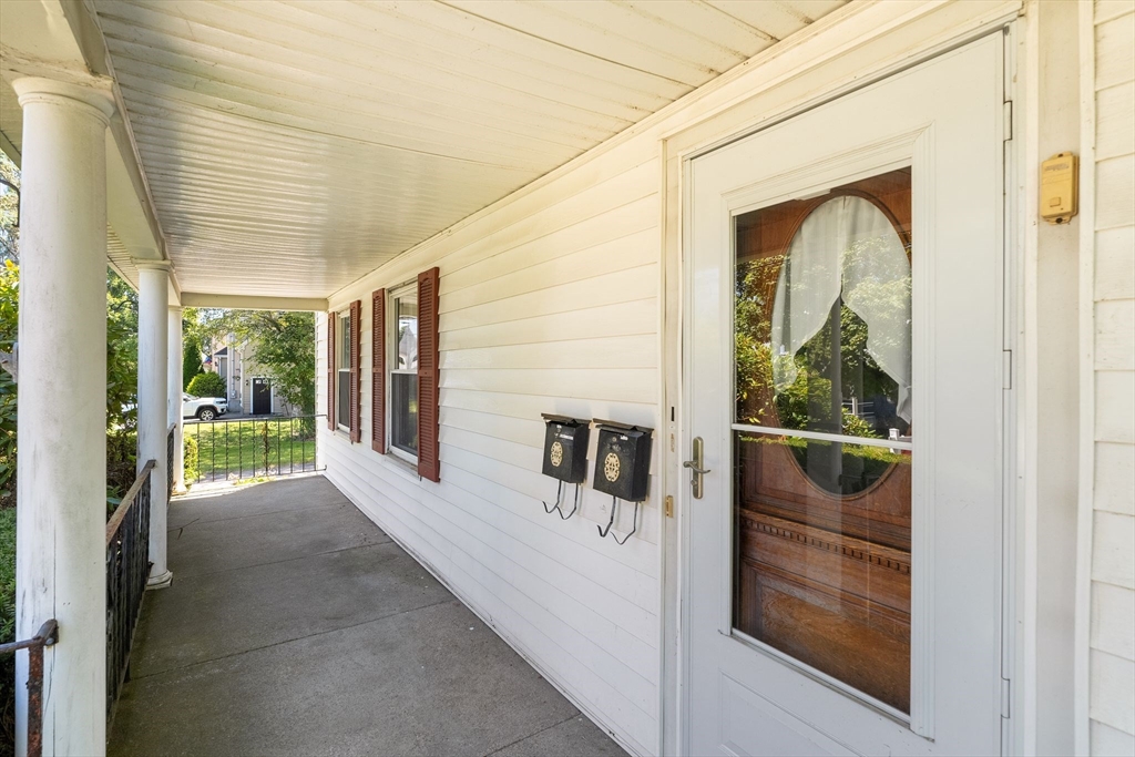 7 Carter Road Braintree, MA 02184 - Photo 2 of 42 a view of a porch with wooden floor and floor to ceiling window