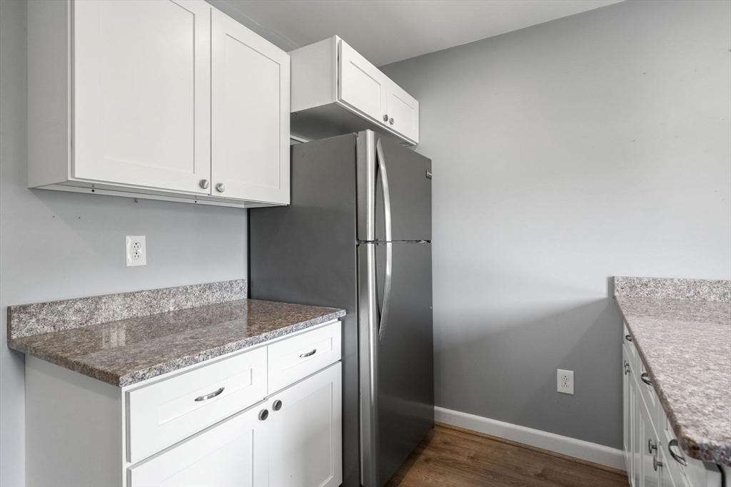 7 Carter Road Braintree, MA 02184 - Photo 22 of 42 a kitchen with granite countertop cabinets and refrigerator