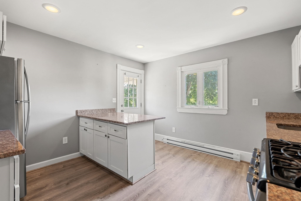 7 Carter Road Braintree, MA 02184 - Photo 23 of 42 a kitchen with granite countertop a stove and a refrigerator