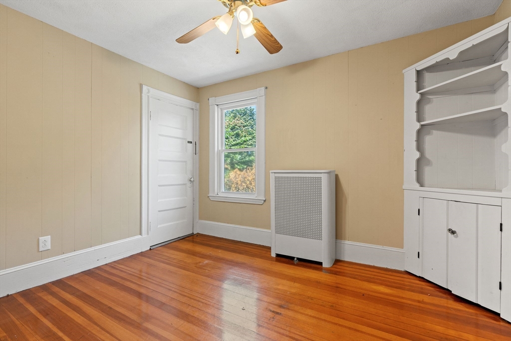 7 Carter Road Braintree, MA 02184 - Photo 24 of 42 an empty room with wooden floor cabinet and windows
