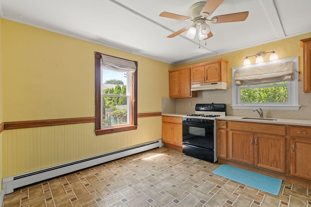 7 Carter Road Braintree, MA 02184 - Photo 3 of 42 a kitchen with stainless steel appliances granite countertop a stove a sink and a microwave