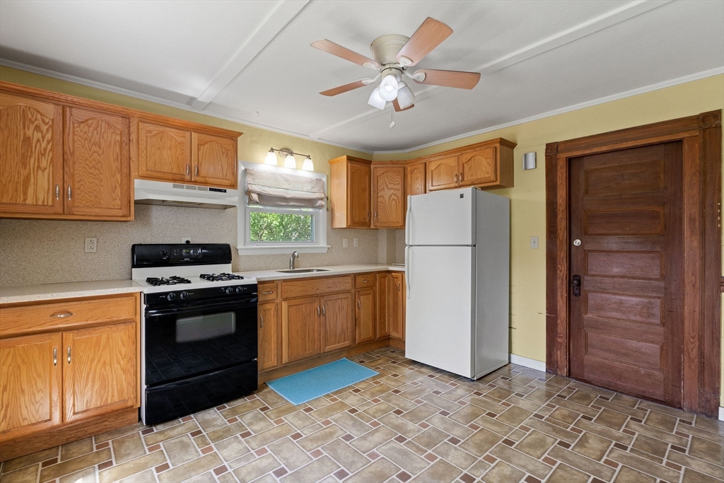 7 Carter Road Braintree, MA 02184 - Photo 4 of 42 a kitchen with a refrigerator a stove top oven and cabinets
