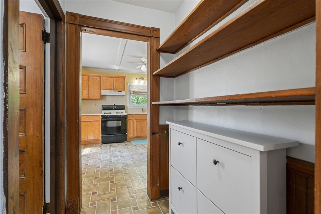 7 Carter Road Braintree, MA 02184 - Photo 6 of 42 a kitchen with a refrigerator and white cabinets