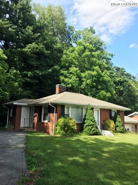 501 Oak Street Boone, NC 28607 - Photo 12 of 12 a front view of a house with a yard and trees