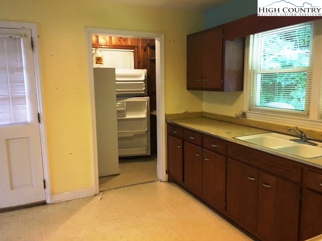 501 Oak Street Boone, NC 28607 - Photo 3 of 12 a bathroom with a granite countertop sink and a mirror