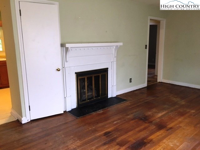 501 Oak Street Boone, NC 28607 - Photo 6 of 12 a view of a livingroom with wooden floor and a fireplace