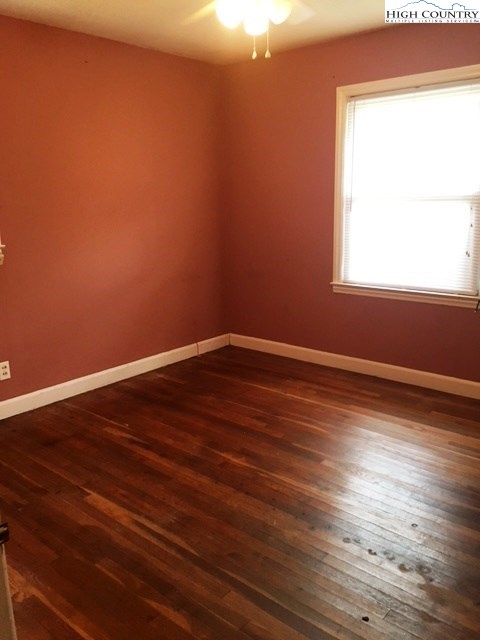 501 Oak Street Boone, NC 28607 - Photo 7 of 12 an empty room with wooden floor and windows