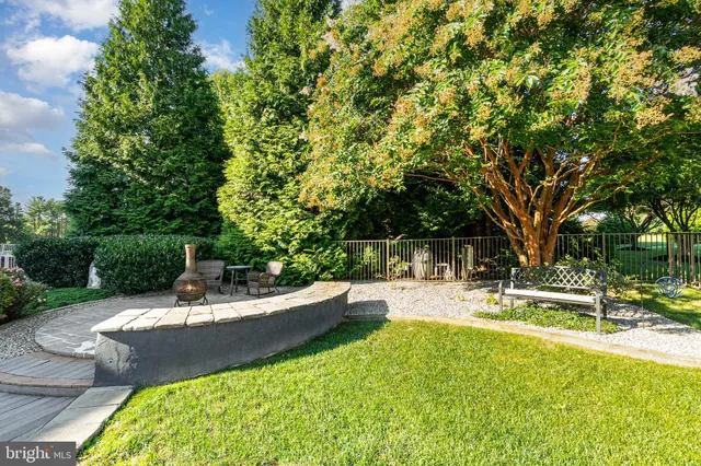 a view of a green field with covered in the background