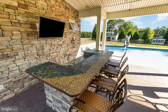 a living room with furniture a fireplace a flat screen tv and potted plant