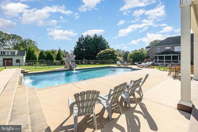 a kitchen with stainless steel appliances granite countertop wooden floor a dining table and chairs