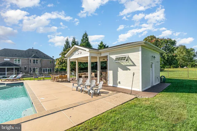 a kitchen with stainless steel appliances granite countertop a sink a stove and a wooden floors