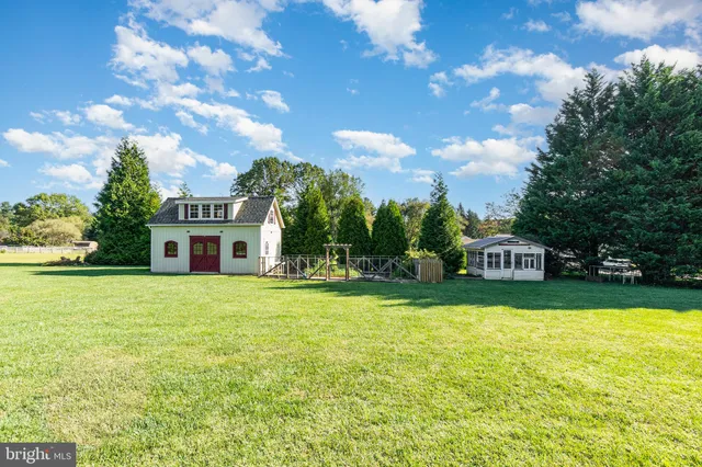 a house view with swimming pool in front of it