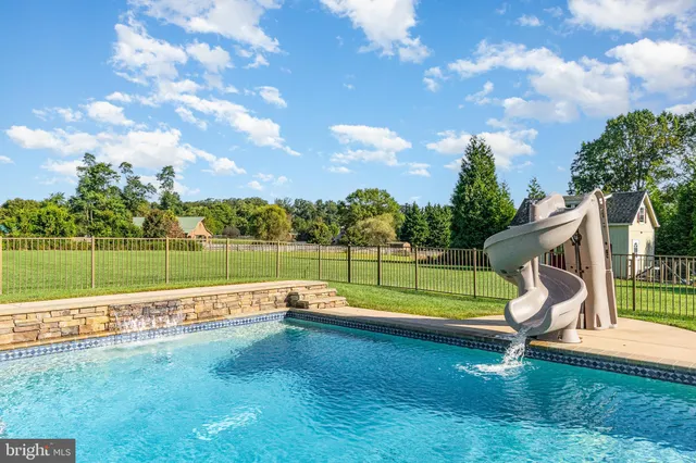 a dining room with furniture a chandelier and wooden floor