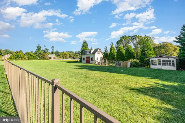 a view of a dining room with furniture wooden floor and chandelier