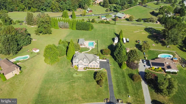 an aerial view of a house with a yard swimming pool outdoor seating and yard