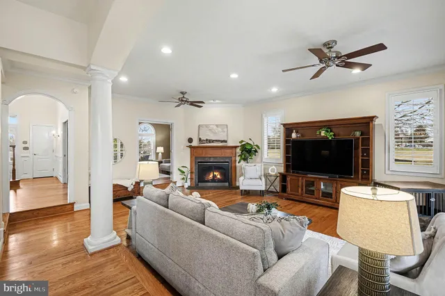 a spacious bedroom with a large bed and a chandelier