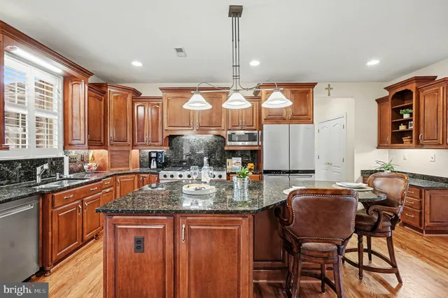 a dining room with furniture potted plants and wooden floor