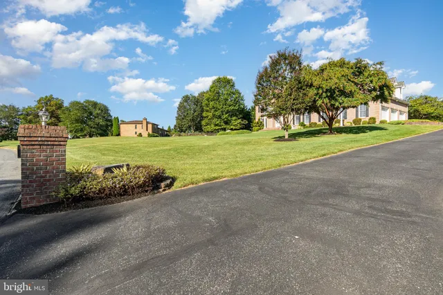 a view of a yard with flower plants and trees