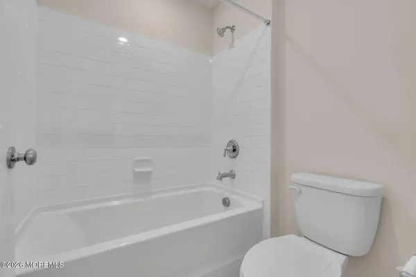 a white bath tub sitting next to a white toilet and sink