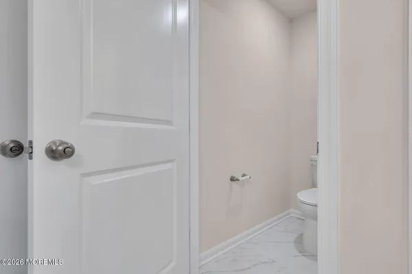 a bathroom with a granite countertop toilet and a shower