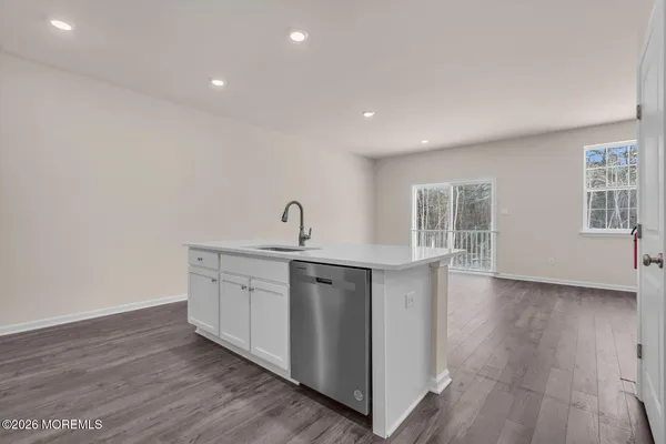 a view of a kitchen with sink dishwasher and wooden floor