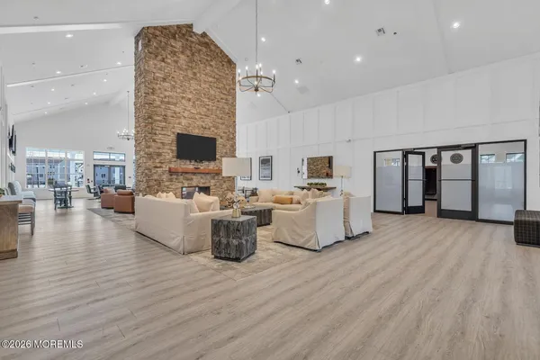 a living room with fireplace furniture and a wooden floor