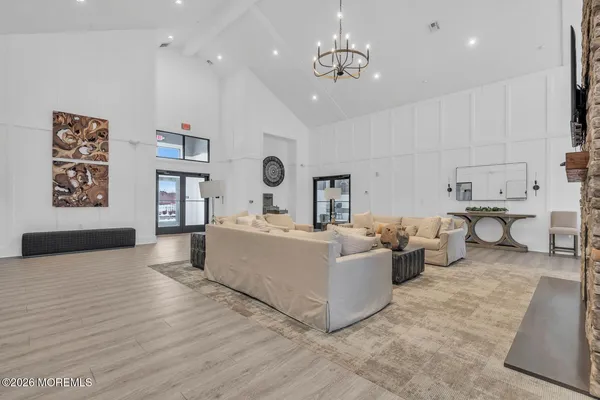 a living room with furniture and a kitchen