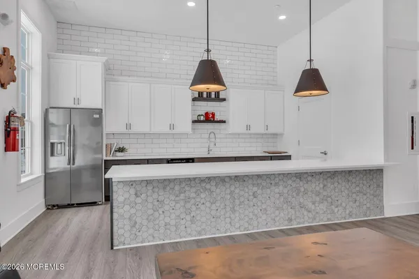 a kitchen with kitchen island granite countertop cabinets and a counter top space