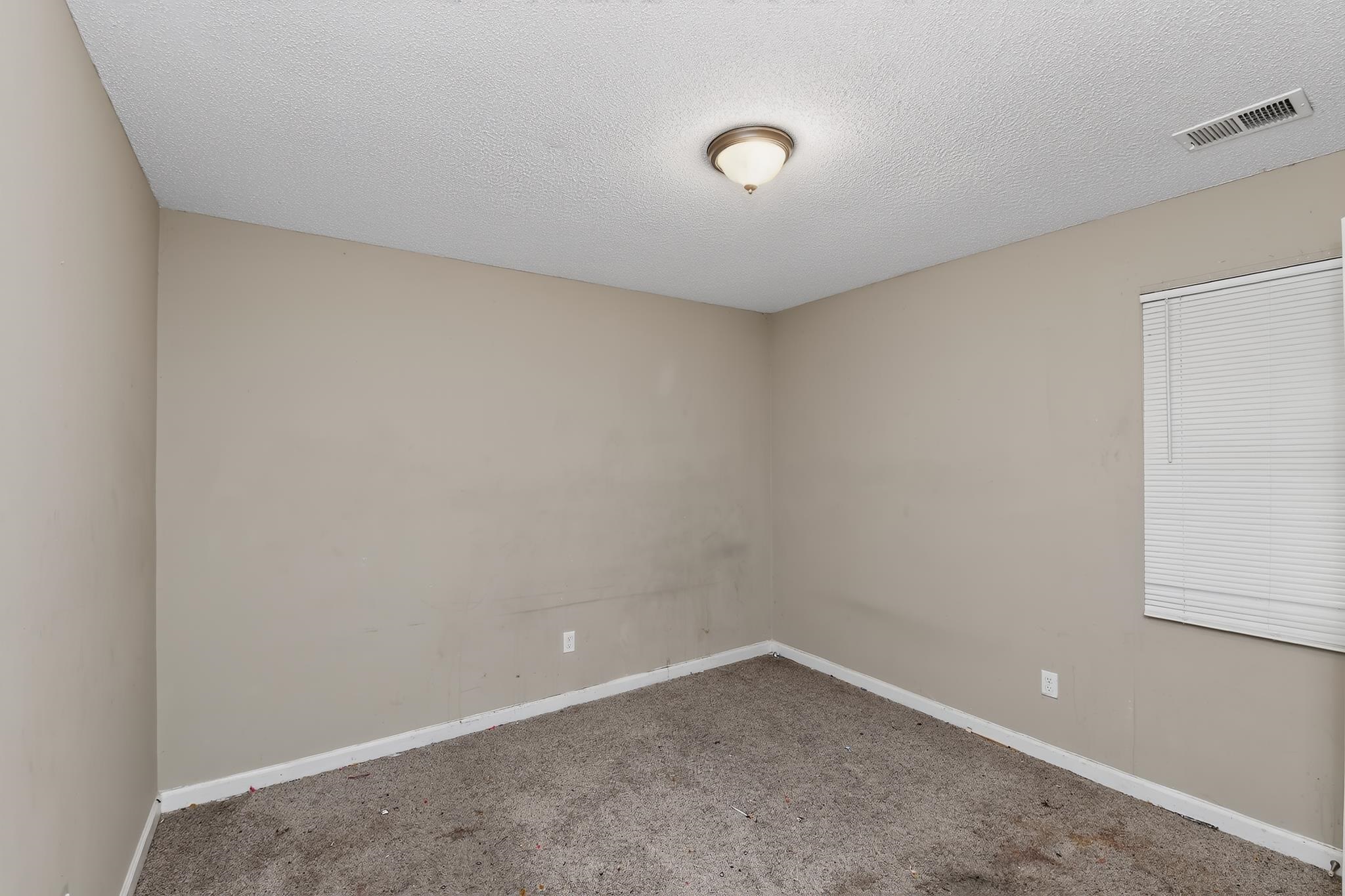 3953 McCain Road Memphis, TN 38109 - Photo 11 of 15 Neutral tone wall paint with white baseboards and textured ceiling