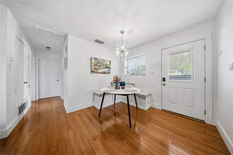 a view of a livingroom with furniture wooden floor and a window