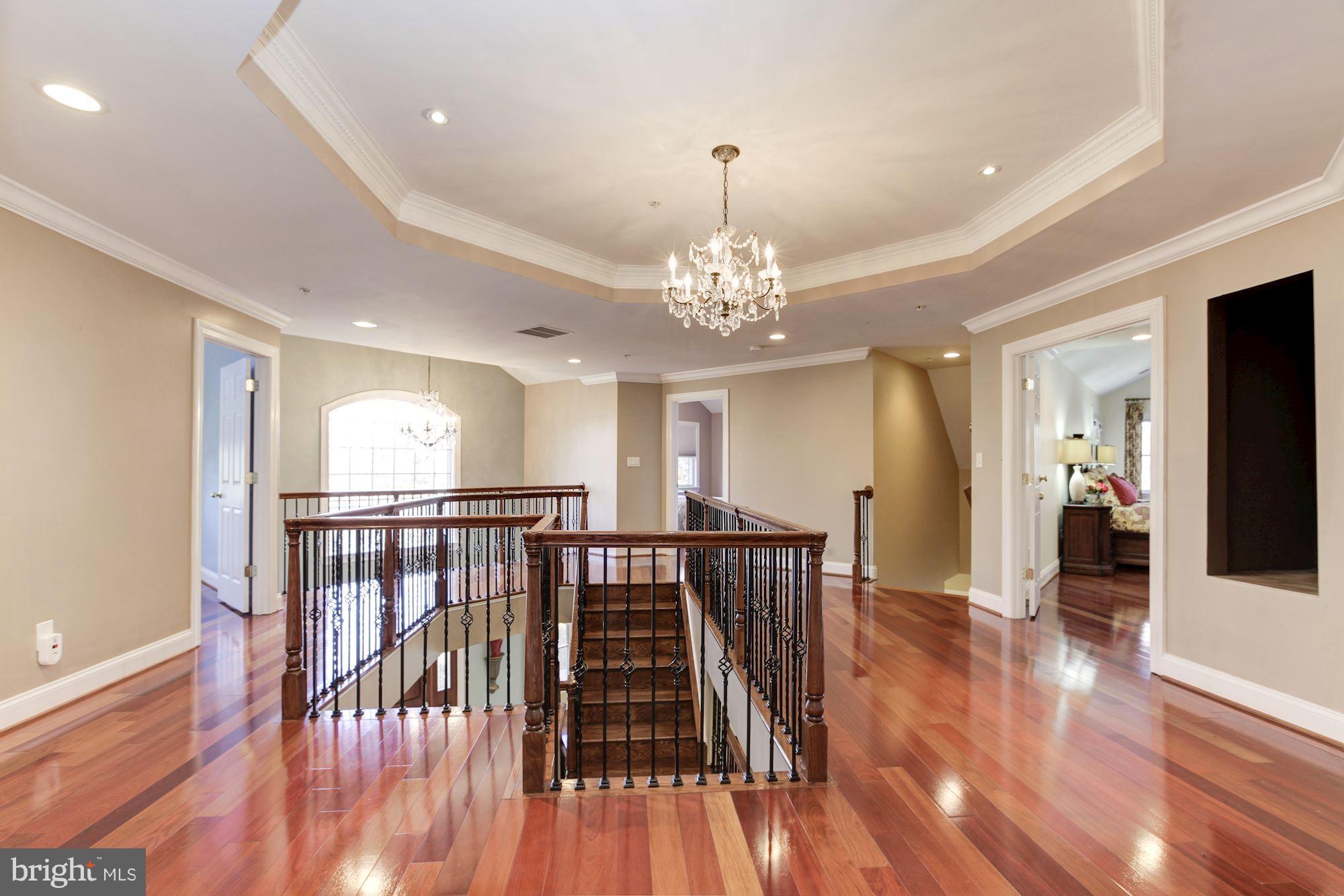 3406 Glorus Place Silver Spring, MD 20902 - Photo 22 of 53 a view of a hallway with wooden floor and chandelier