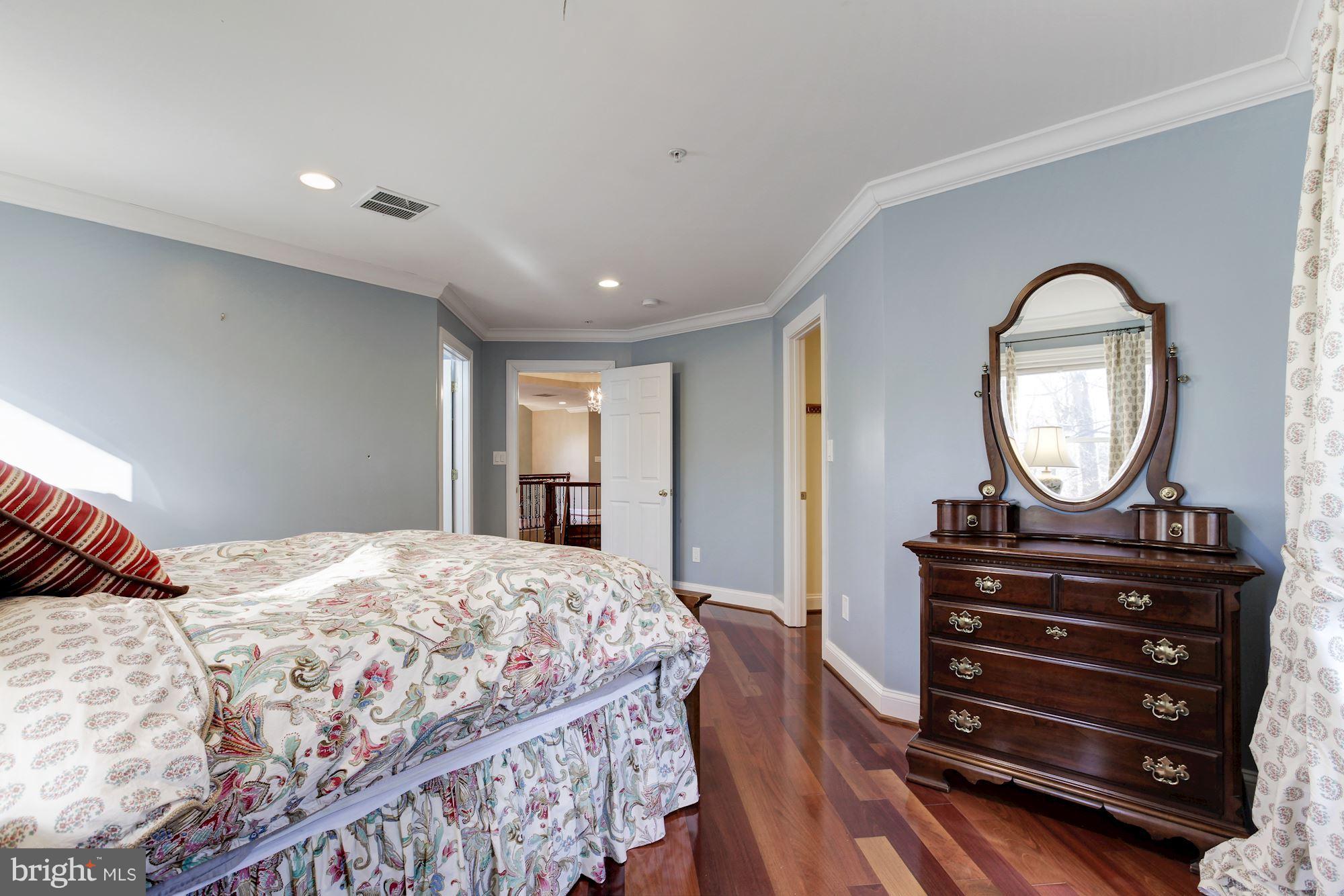 3406 Glorus Place Silver Spring, MD 20902 - Photo 37 of 53 a bedroom with a bed a dresser and a mirror