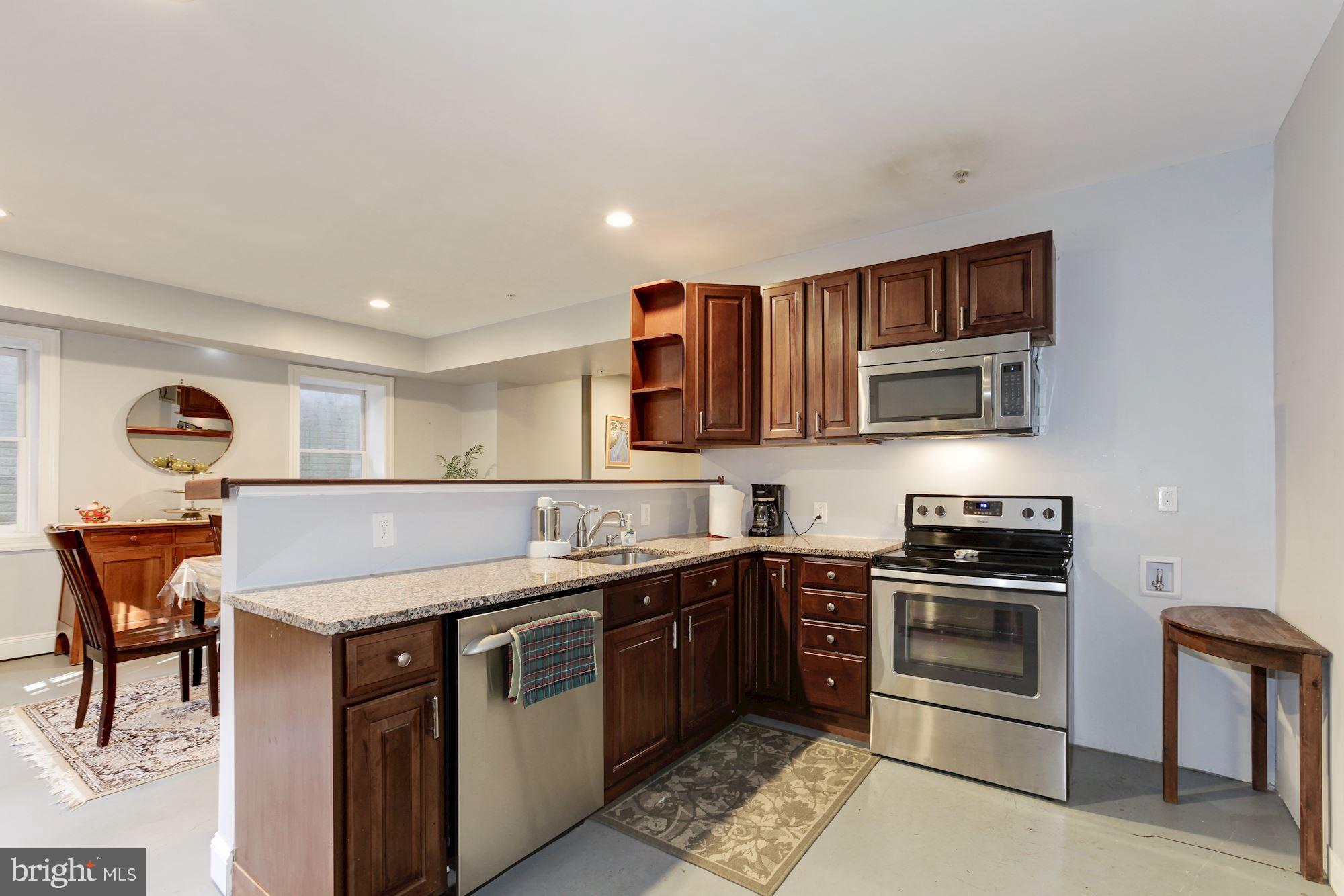 3406 Glorus Place Silver Spring, MD 20902 - Photo 43 of 53 a kitchen with stainless steel appliances granite countertop a stove a sink and a refrigerator